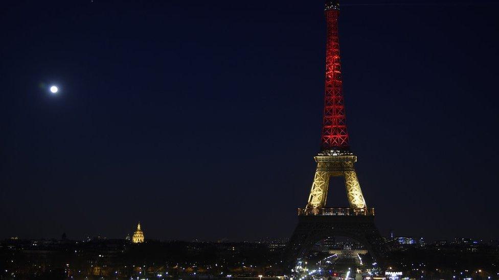 Eiffel Tower in Paris illuminated in colours of the Belgian flag