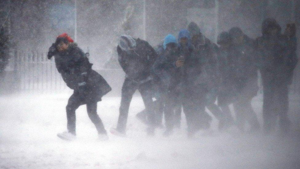 Boston residents struggle in the wind and snow