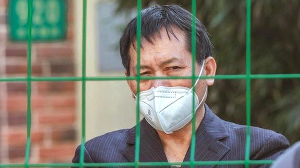 A woman talks with a person in quarantine through the fence, amid new Covid-19 lockdown, in Shanghai, China, 10 October 2022