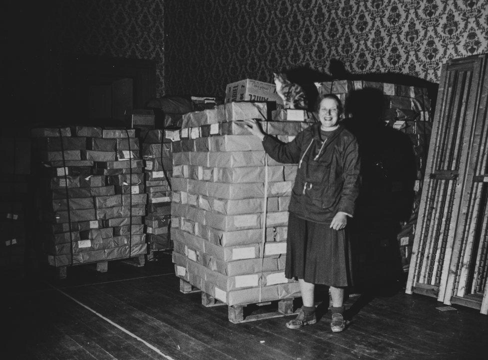 Denis Dobson's books in piles having being brought to Brancepeth Castle