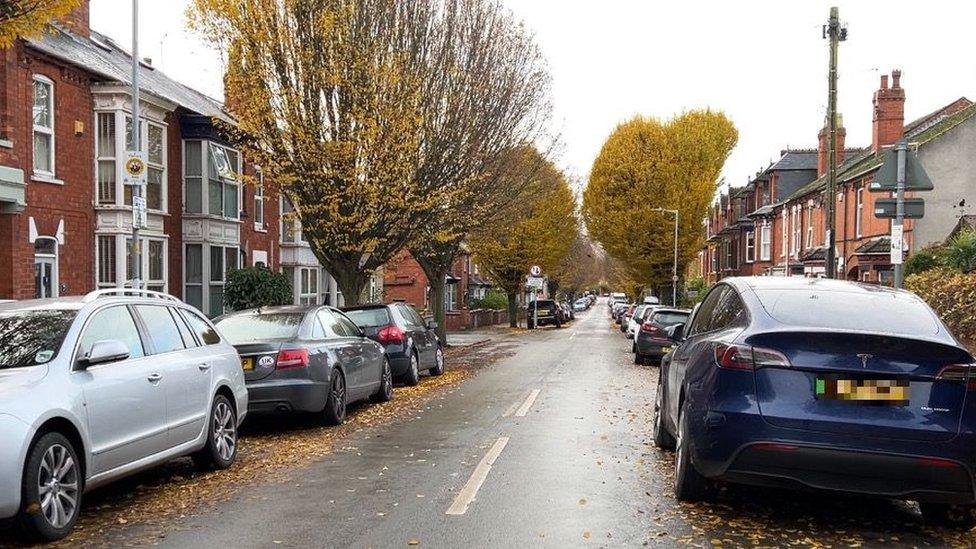 Road with cars parked on it