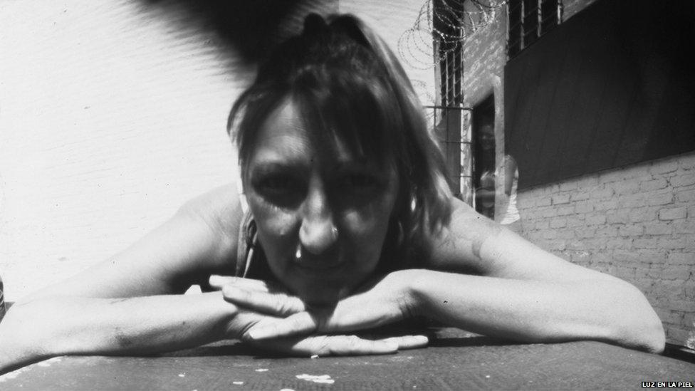 A pinhole photograph shows a woman