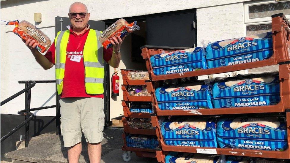 David Jones holding loaves of bread