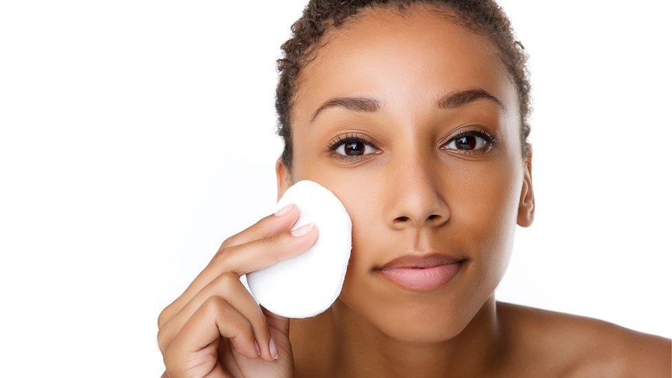 A woman removing makeup