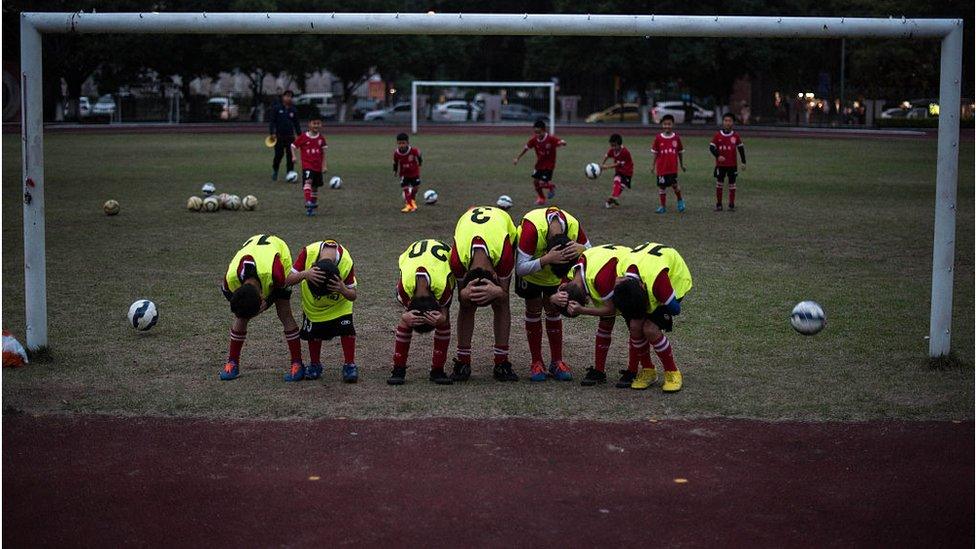 children playing football in China