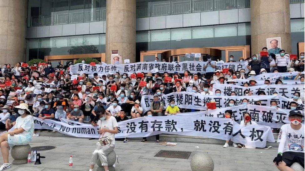 Protesters gather outside a People's Bank of China building in Zhengzhou on Sunday.