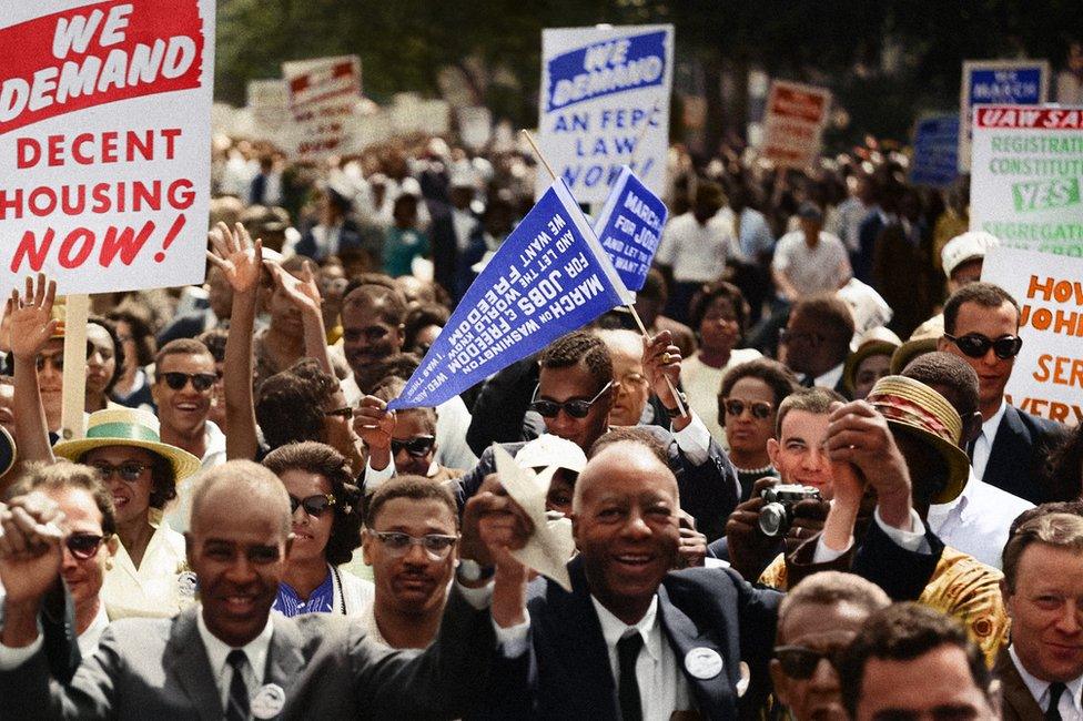 Marchers cheer and wave placards at the Civil Rights March on Washington