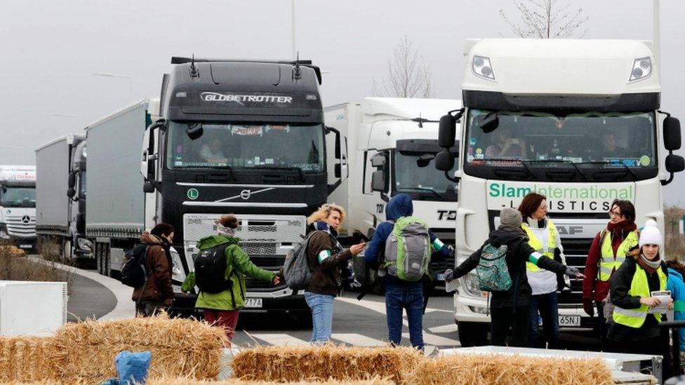 Activists formed a human chain, lay on hay bales and dumped old fridges and microwaves outside Amazon depot