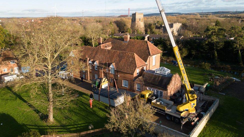 The spa pool being lifted out by crane