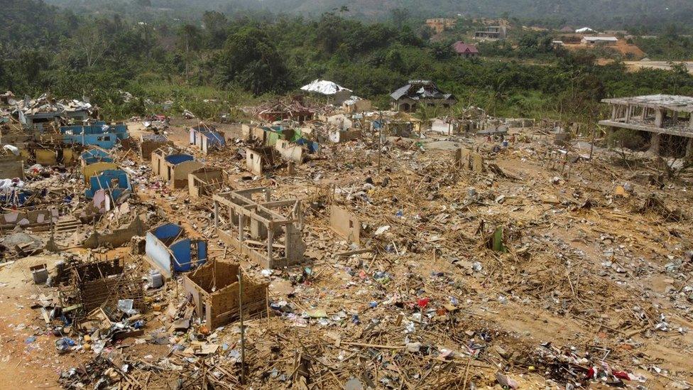 A view shows debris of houses and other buildings that were destroyed when a vehicle carrying mining explosives detonated along a road in Apiate, Ghana, January 21, 2022