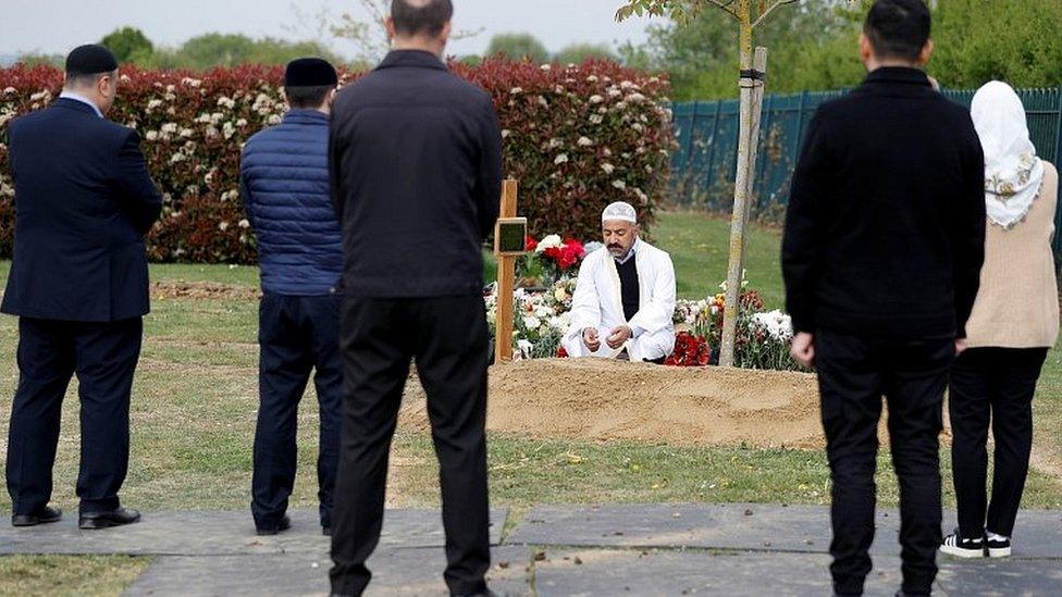 An imam leading the funeral of Ozcan Aygin in Romford