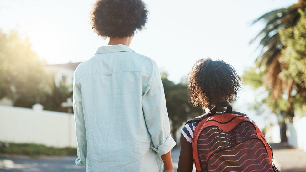 Parent and child walking to school