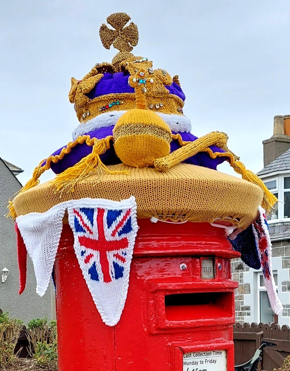 A knitted crown, orb and sceptre and union jack bunting