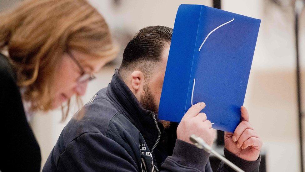 Former nurse Niels Hoegel, accused of killing more than 100 patients in his care, arrives with his lawyer Ulrike Baumann, in the courtroom on 30 October 2018