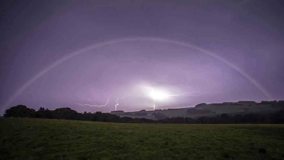 Lightning framed by moonbow