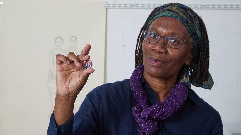 woman-holding-windrush-coin.