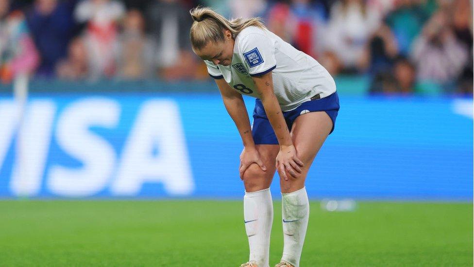 Georgie Stanway with her hands on her knees looks disappointed after missing penalty