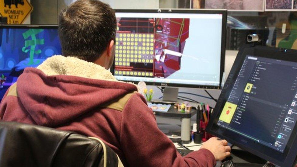 games designer at desk