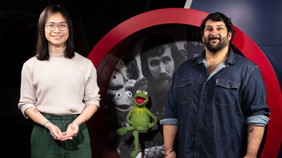 Arjan Mann (right) and Calvin So (left) holding the fossil skull of Kermitops in front of the Kermit the Frog