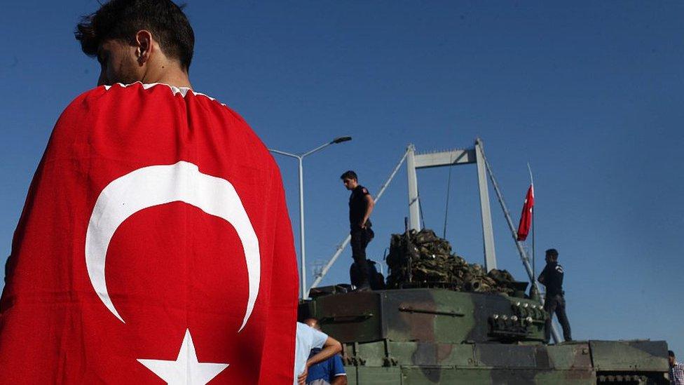 A boy wearing a Turkish flag in a show of loyalty to the state following the failed coup attempt in July 2015