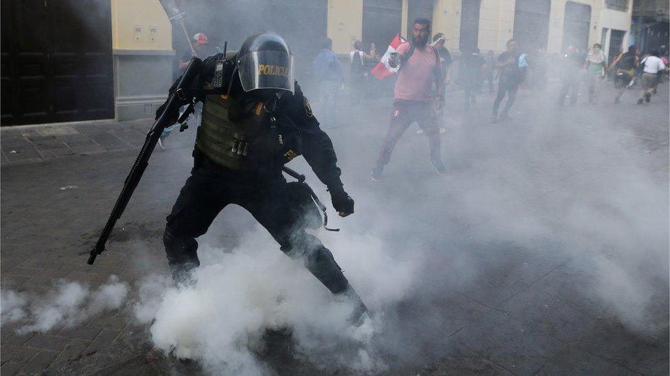 Protesters clash with police during a march after Peruvian President Pedro Pablo Kuczynski pardoned former President Alberto Fujimori in Lima, Peru, December 25, 2017