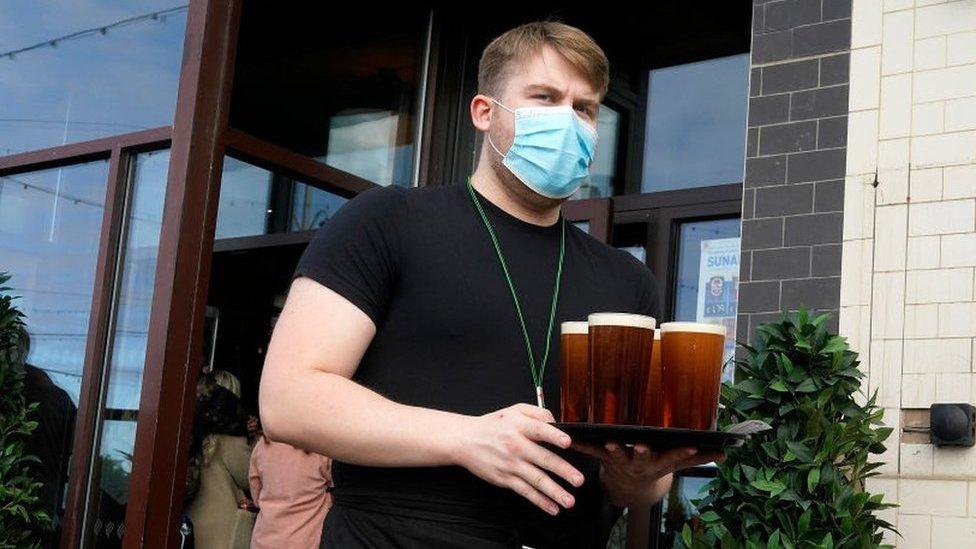 Barman carrying tray