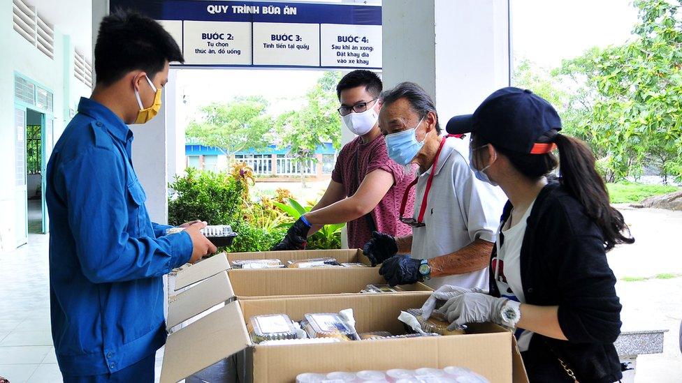 Mr Ngo helping to provide meals to camps