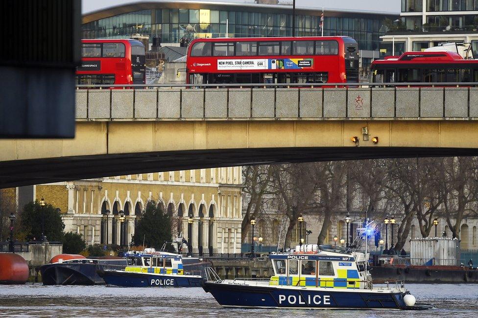 Boats from the Metropolitan Police Marine Policing Unit patrol near the scene