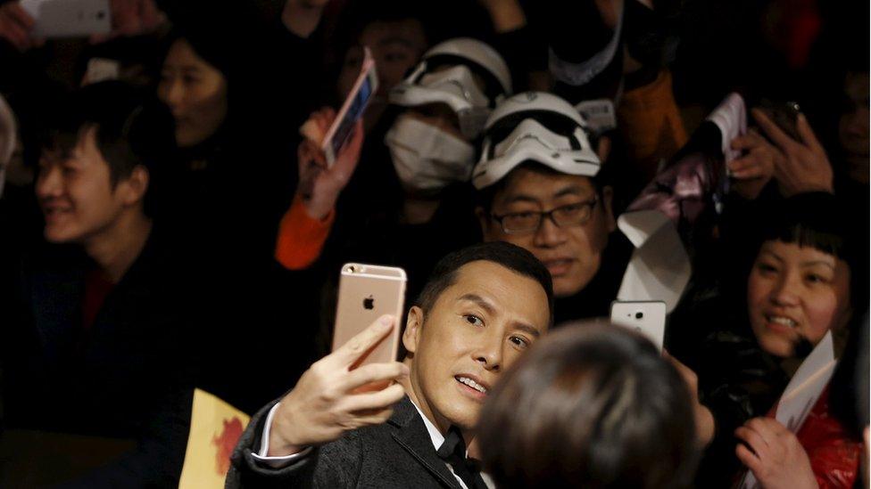 Hong Kong actor Donnie Yen takes a selfie at the Shanghai premiere of the "The Force Awakens"