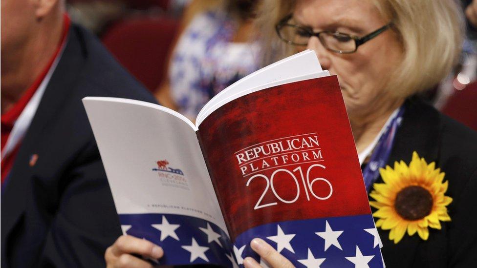 A woman reads the Republican party platform