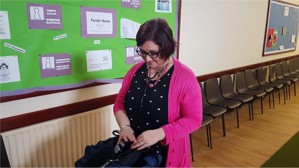 Nurse Jennifer Gault looking through her bag.