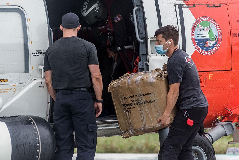 US Coast Guard carry medical supplies to the Ofatma Hospital in Les Cayes, Haiti, on 17 August 2021