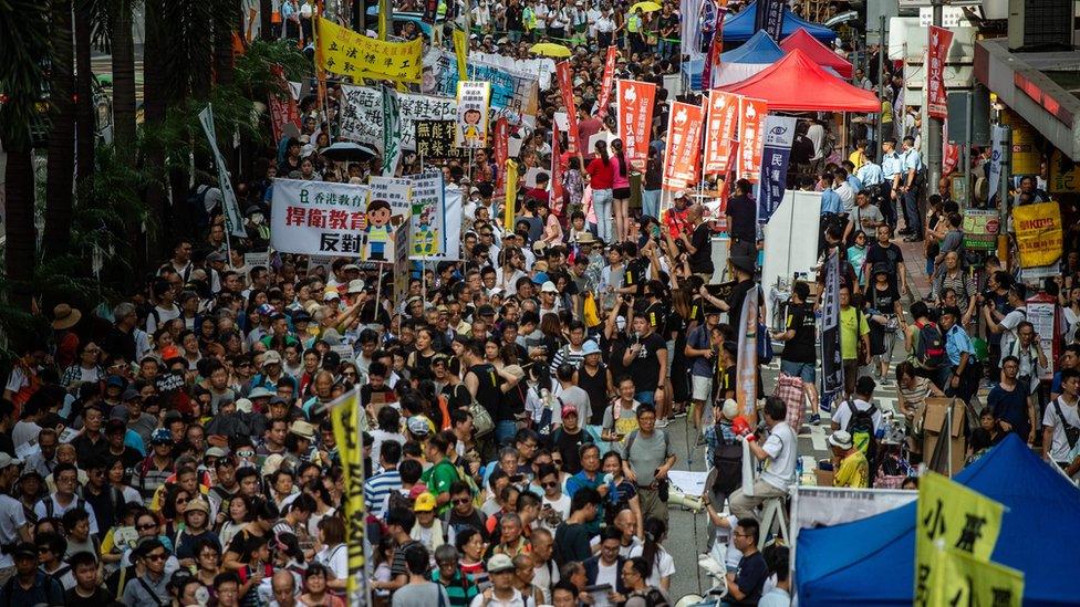 People attend a protest march in Hong Kong on July 1, 2018, to coincide with the 21st anniversary of the city's handover from British to Chinese rule.