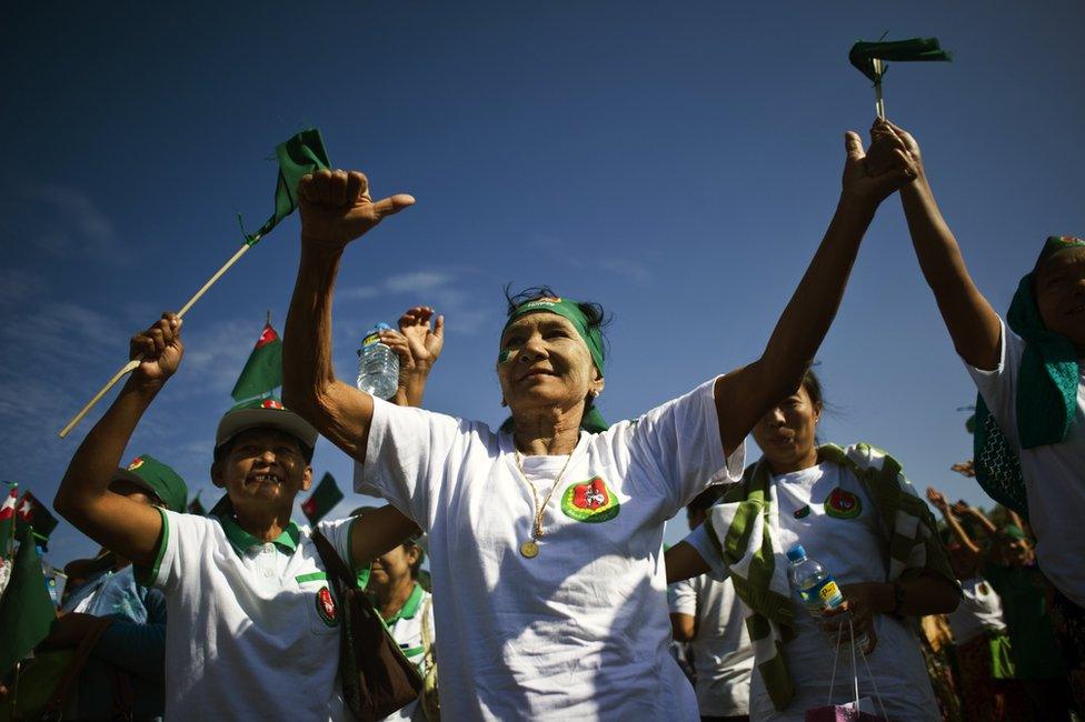 Supporters of the army-backed ruling Union Solidarity and Development Party (USDP) dance to the party"s song during a campaign rally in Mawbi outside of Yangon on 3 November 2015