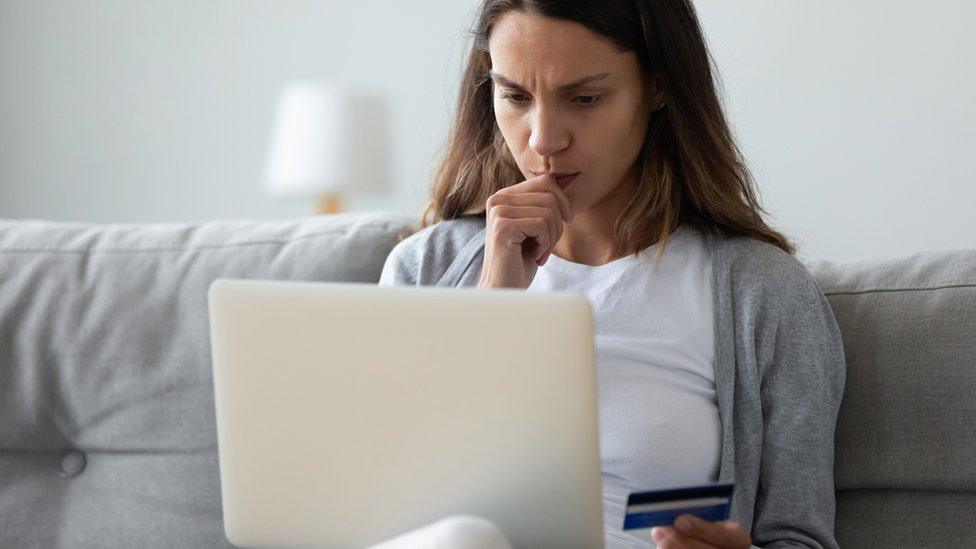 Woman looking at laptop