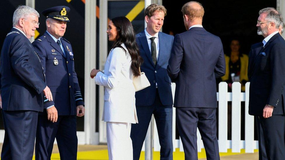 Prince Harry, Duke of Sussex (right) and his wife, Meghan, Duchess of Sussex (left) arrive on the Yellow Carpet before the start of the Invictus Games in The Hague