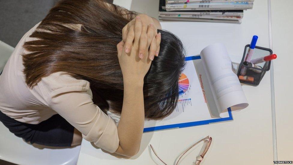 Woman with her head in her hands