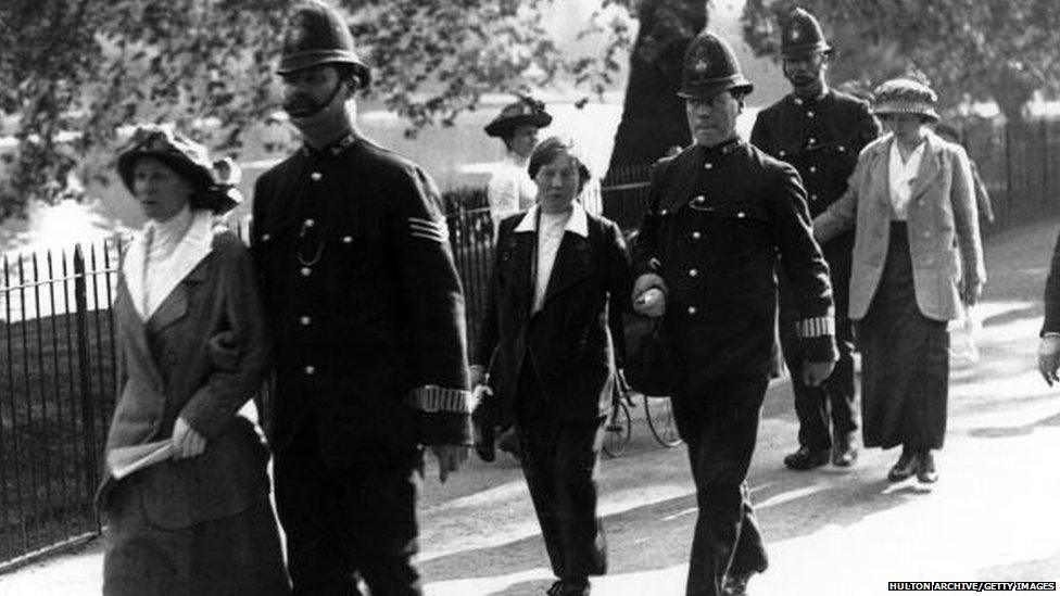 Arrested protesters are led away by the police, after the suffragette attack on Buckingham Palace