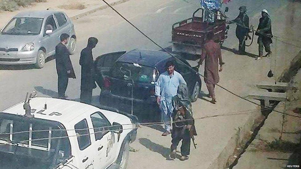 Taliban fighters patrol the streets of Kunduz