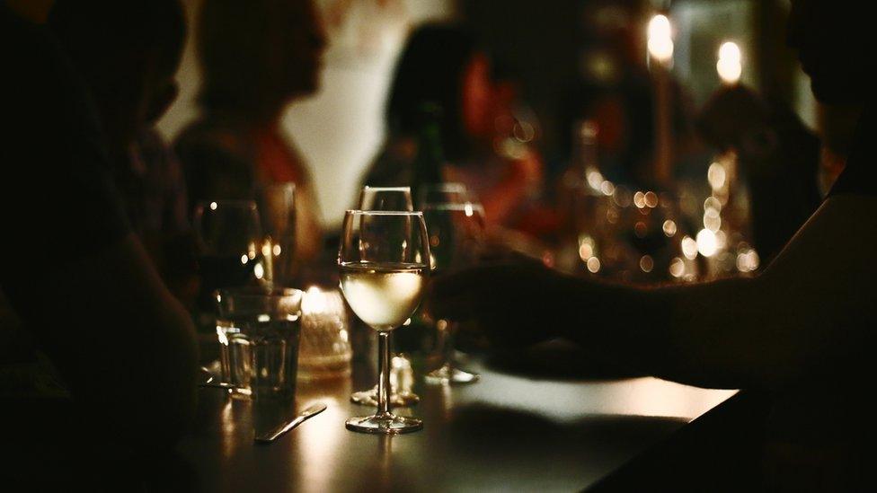 People dining in dimly lit room