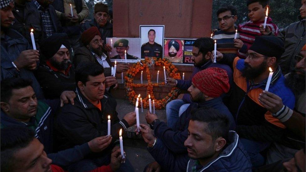 Indian people and members of National Human Rights and Crime Control Organization light candles in front of portraits of Indian security personnel who lost their lives in the Pathankot militant attack at Air Force base, during a tribute paying ceremony in Amritsar, India, 03 January 2016