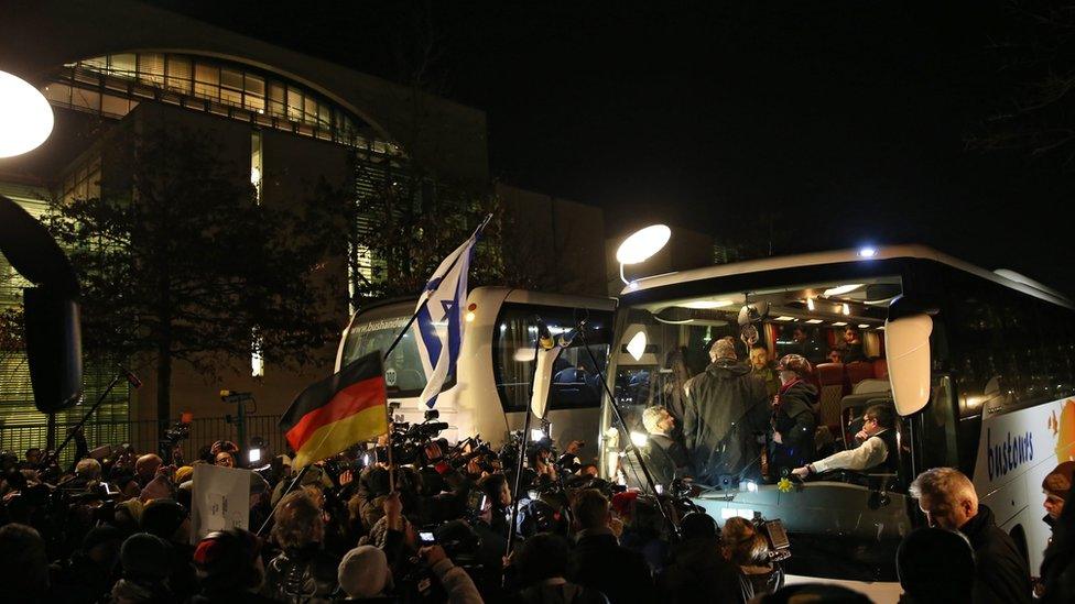 A bus carrying refugees from Landshut arrives at the federal chancellery in Berlin, Germany (14 January 2016)