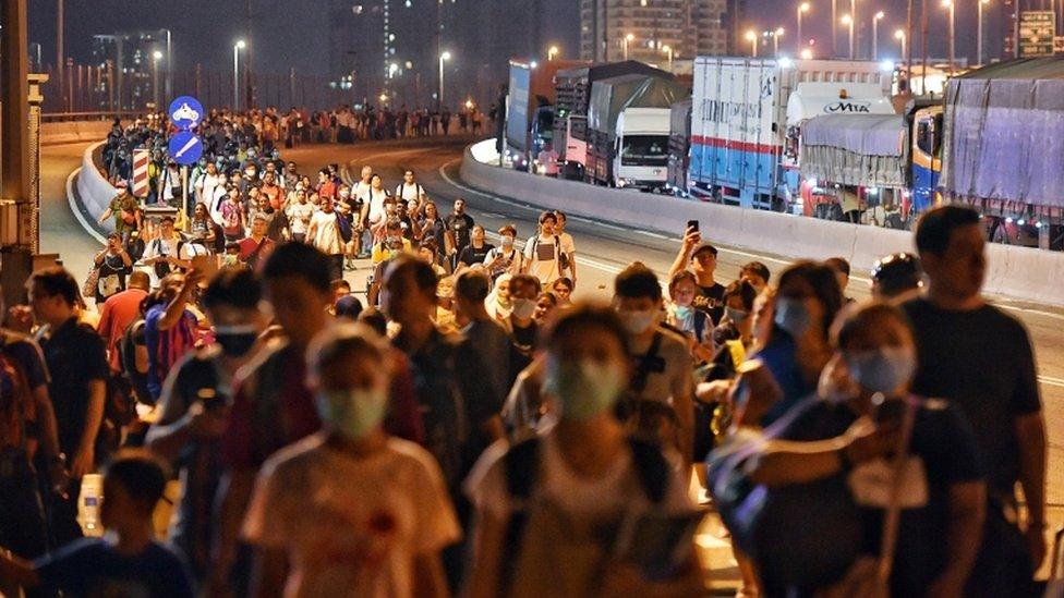 People queue to enter Singapore from Malaysia before a travel ban started