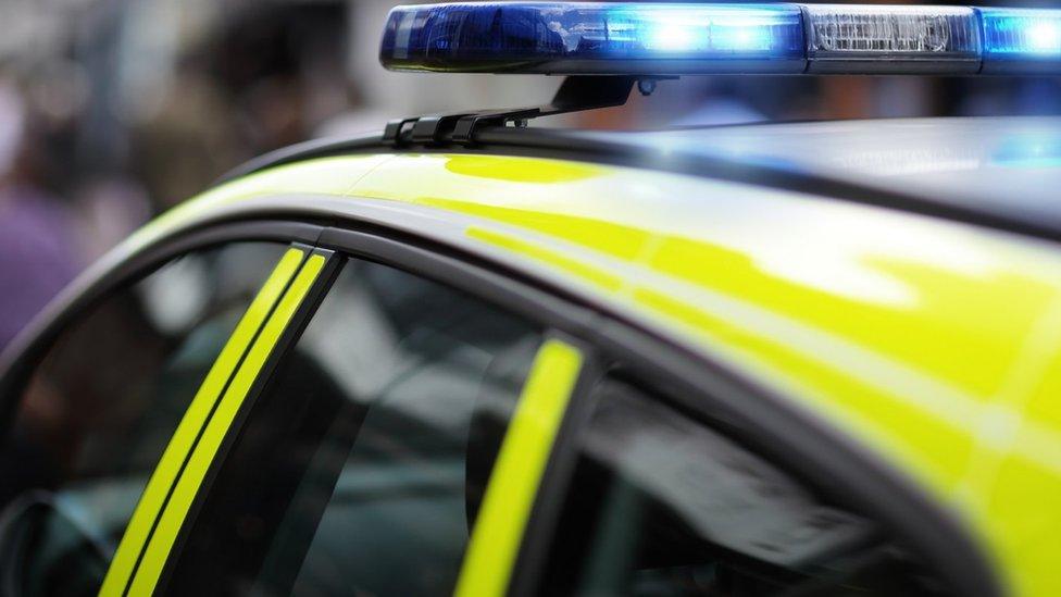 A police car with blue lights flashing