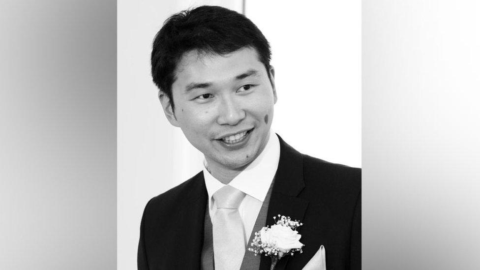 Kar Hao Teoh in a black and white photo. He is wearing a morning suit with flower corsage in lapel.