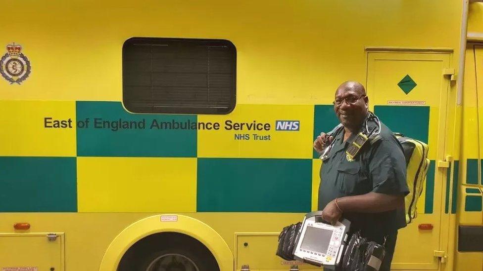 Paramedic with kit bag next to ambulance