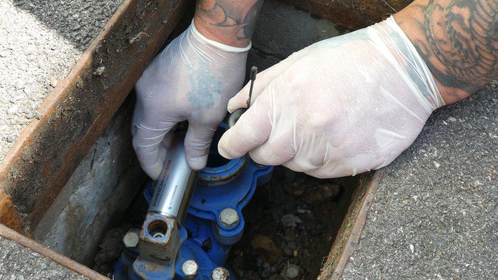 Water leak sensor being installed