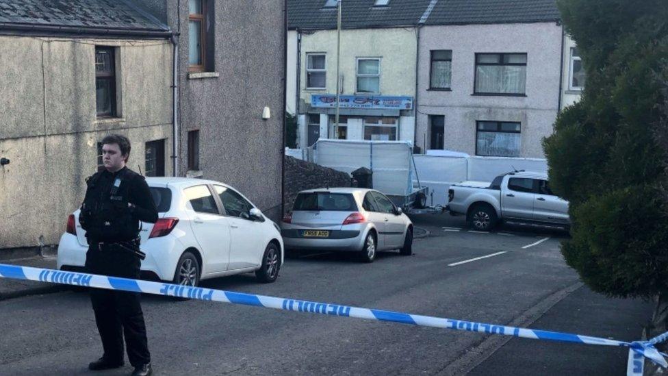 A police officer stands at the cordon in Ynyswen