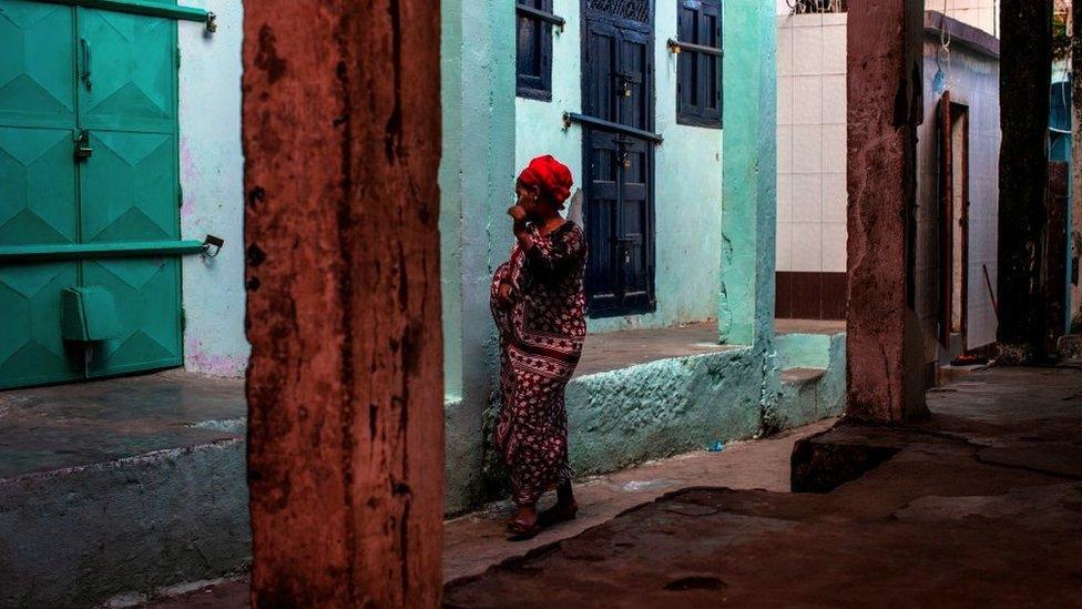 A woman is pictures in the medina of Mutsamudu, the capital of Anjouan Island, Comoros, March 2019