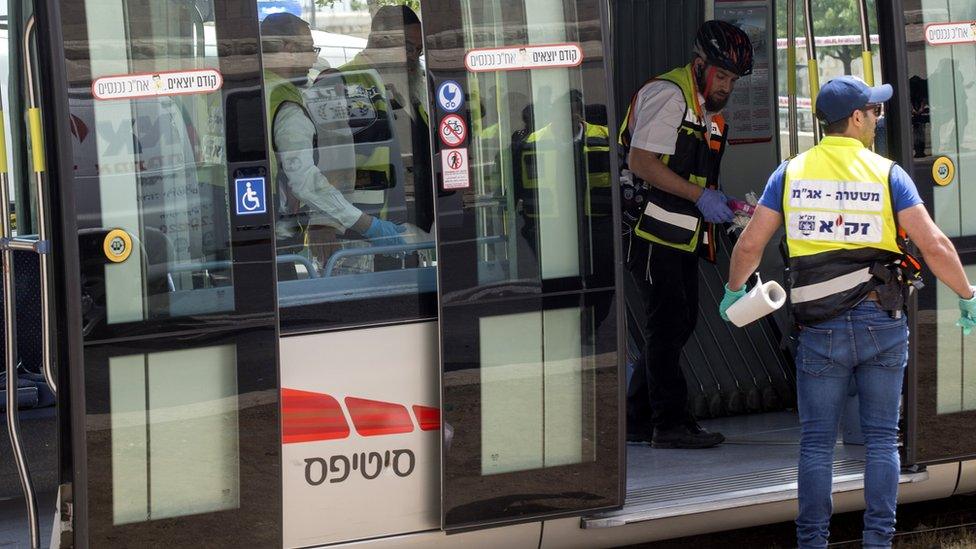 Officials inspect the scene of the stabbing attack